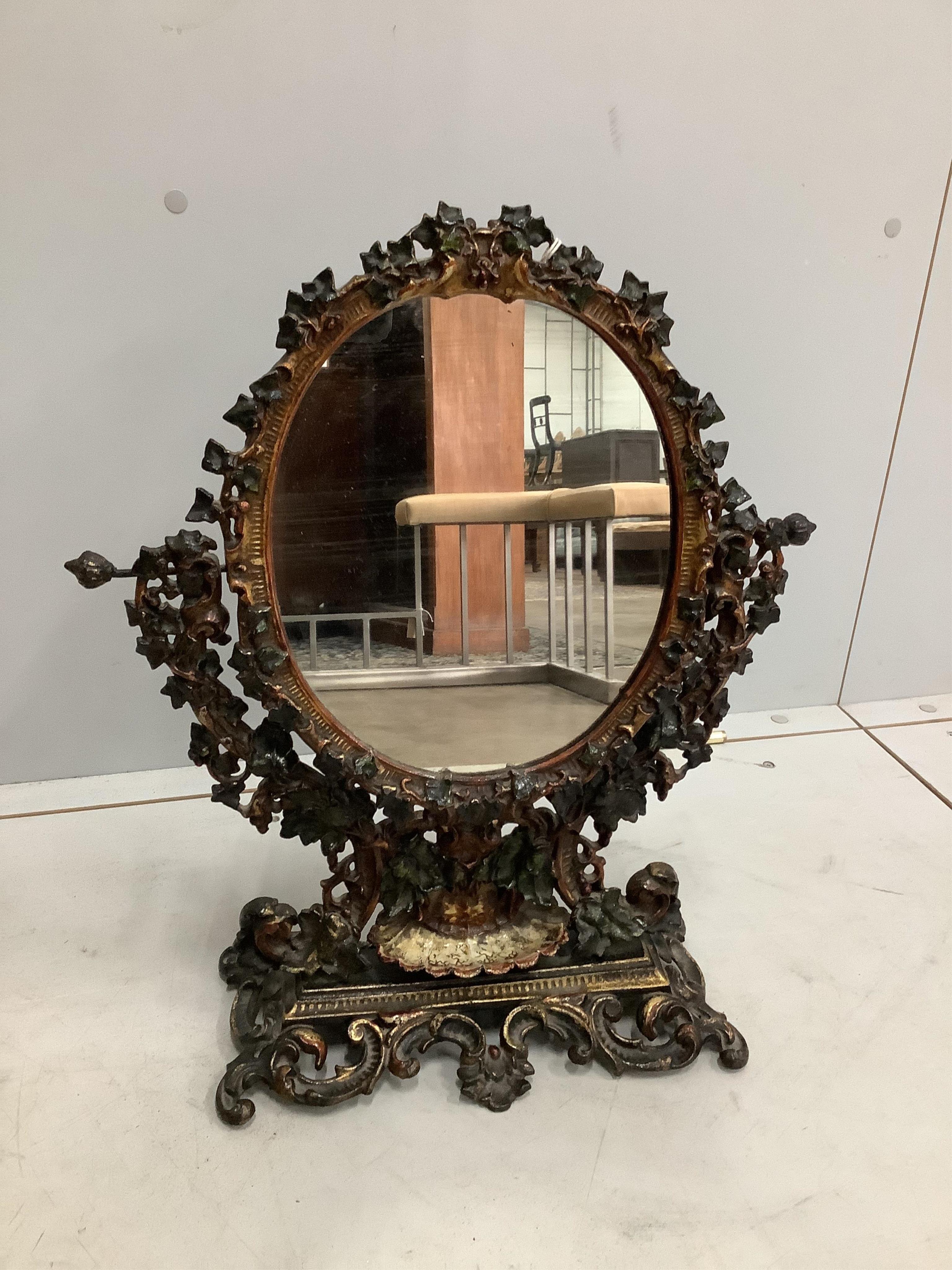 A Victorian style painted cast iron toilet mirror, width 42cm, height 50cm